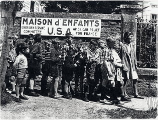French children wait in line to receive assistance...