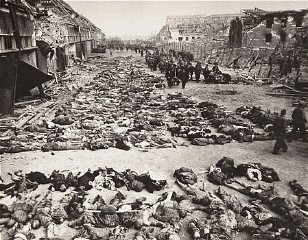 German civilians remove the bodies of prisoners killed...