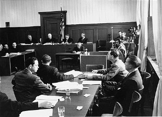 Members of the prosecution team (foreground) during...