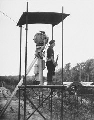 A British guard in a watchtower at Poppendorf displaced...