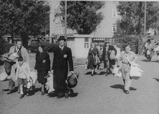 Jews proceed to an assembly point before deportation...