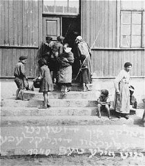 Women and children at the door of a soup kitchen maintained...
