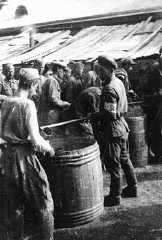 Soviet prisoners of war receiving their meager rati...