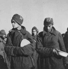 Soviet prisoners of war wait for food in Stalag (prison...