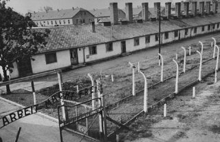 View of the kitchen barracks, the electrified fence...