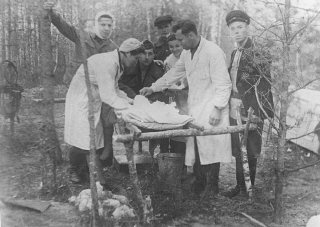 A wounded partisan is treated in a field hospital belonging...