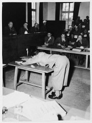 A prosecution witness demonstrates the position prisoners...