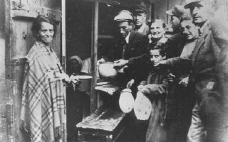 Poverty in the ghetto: residents wait for soup at a...