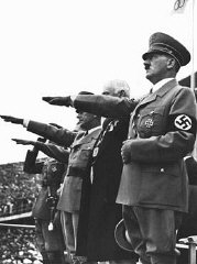 Adolf Hitler salutes the Olympic flag at the opening...