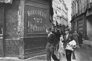 A young man in the Jewish quarter of Paris wears the...