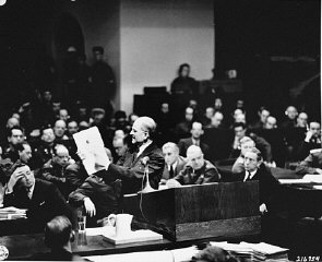 In the International Military Tribunal courtroom, executive...