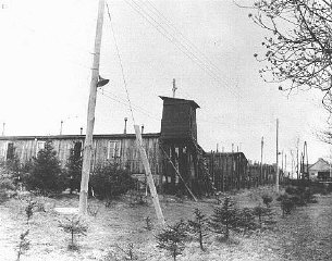 View of a watchtower and prisoner barracks at the Ohrdruf...
