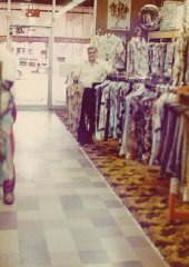 Aron standing in Howard's men's clothing store (named...