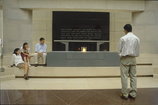 Visitors view the eternal flame in the Hall of Remembrance...