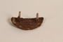 Rusted heel plate with a screw and nail recovered from Chelmno killing center