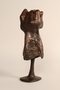 Bronze sculpture of a woman resting in the shelter of a cupped hand