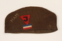 Brown hat with a triangular patch bearing a J and initials worn by John Bolé