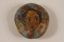 Stone with a painted portrait of a young girl with short hair who was killed in a concentration camp