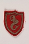 Red badge embroidered with the Warsaw Mermaid, emblem of Warsaw, and of the 2nd Polish Corps