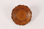 Wooden plate with a carved floral rim made in a displaced persons camp