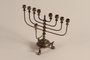 Hanukkah menorah with fish shaped feet that was used in the Tarnow Ghetto