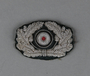 German Army officer's visor cap insignia with a silver wire oak leaf wreath and cockade acquired by a US soldier